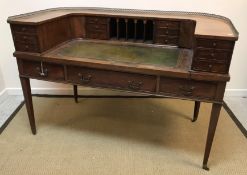 A mahogany Carlton House desk in the Regency style, the curved superstructure with various drawers,