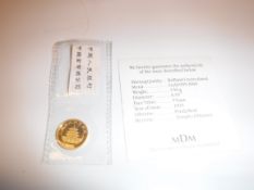 An uncirculated gold 1995 5 Yuan piece bearing Panda Bear and Temple of Heaven