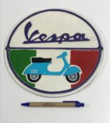 A modern painted cast metal sign "Vespa",