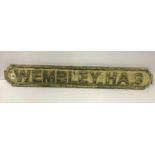 A modern wooden sign inscribed "Wembley HA9",