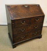 A 19th Century ash bureau, the plain top over a sloping fall enclosing a basic fitted interior,