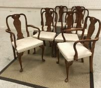 A set of eight early to mid 20th Century walnut framed dining chairs in the Queen Anne style with