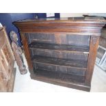 An oak three tier bookcase raised on a plinth base, 118 cm wide x 31 cm deep x 101 cm high,