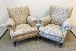 A pair of Victorian upholstered scroll arm chairs in the Howard manner, with shaped side rails,