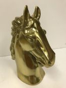 A gold coloured cast aluminium horse head ornament 45cm high