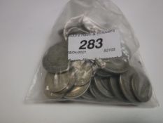 A small bag containing various pre-war silver coinage, including crowns,