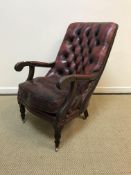 An early 20th Century red leather upholstered elbow chair,