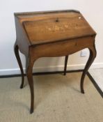 A late 19th Century French rosewood and marquetry inlaid bureau de dame,