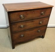A Victorian chest of three long drawers with pressed brass handles on bracket feet,