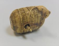 A 19th Century ivory netsuke in the form of a basket with rat on top and a articulated snake poking