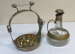 A mid 20th Century glass and plated mounted Vodka tantalus with onion shaped jug and lockable stand,