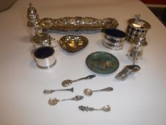 A collection of silver wares to include a pierced drum mustard with associated blue glass liner (by