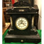 A late Victorian slate and marble cased mantel clock with gilt lined scrolling foliate decoration,