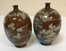 A pair of Chinese cloisonne egg shaped vases with narrow necks,