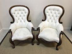 A pair of Victorian spoon back salon chairs with mahogany show frames and buttoned backed cream kid