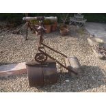 A Victorian cast iron garden roller with turned wooden handles, 48 cm diameter,