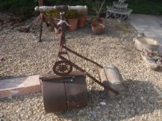 A Victorian cast iron garden roller with turned wooden handles, 48 cm diameter,