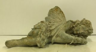 A modern cast iron figure of a fairy sleeping, approx 40 cm long,