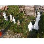 A collection of seven various concrete garden ornaments including gnome cobbler, gnome with basket,