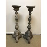A pair of carved wood and painted candle stands in the 17th Century Italianate manner, 152.