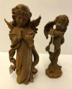 A cast iron figure of a praying angel 31 cm and a cast iron figure of a cherub with butterfly on