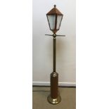 A modern brass and copper standard lamp as a Victorian street lamp,