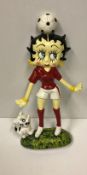 A modern painted cast iron figure of Betty Boo with football on head,