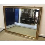 A modern rectangular wall mirror with gilt and silvered frame and bevelled plate, approx 121.