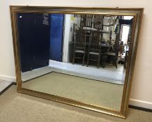 A modern rectangular wall mirror with gilt and silvered frame and bevelled plate, approx 121.