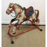 A Tri-ang rocking horse on red painted tubular base (for restoration),