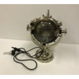A polished metal search light type table lamp on swivel base 42 cm high CONDITION REPORTS