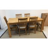 An Arthur Llewellyn Jenkins oak dining room suite comprising rectangular table,