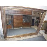 A modern rectangular gilt framed wall mirror, the plate with bevelled edge,