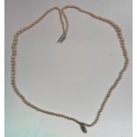 A two strand graduated pearl necklace, the navette form clasp with central small diamond (approx 0.