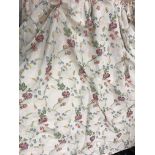A pair of silk style cream ground multi-coloured floral decorated interlined curtains with taped
