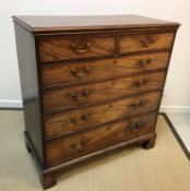 A 19th Century figured mahogany chest of two short over four long graduated drawers with brass swan