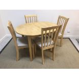 A modern beech extending dining table wi