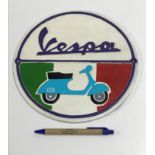 A modern painted cast metal sign "Vespa"