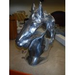 A polished aluminium horse head ornament