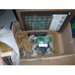 A box containing various stamps and coin