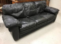 A modern black leather three seat sofa,