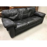 A modern black leather three seat sofa,