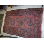 An Afghan rug, the central panel set wit