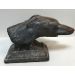 A patinated terracotta sculptural study of two Greyhound heads on a plinth base, 47 cm long x 29