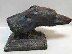 A patinated terracotta sculptural study of two Greyhound heads on a plinth base, 47 cm long x 29