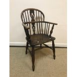 A 19th Century Nottinghamshire beech and elm stick back elbow chair, the pierced back splat with