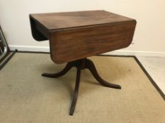 A 19th Century mahogany Pembroke table, the rounded rectangular drop-leaf top on a central turned