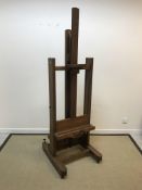 A circa 1900 French oak adjustable two sided artist's easel, bearing maker's stamp "Nostellet