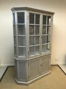 An OKA bow fronted display cabinet with louvre door base, 149 cm wide x 43 cm deep x 210 cm high