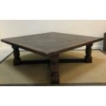 A modern oak coffee table in the 17th Century manner, the square top with cleated ends, raised on